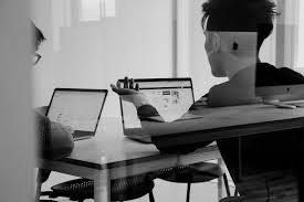 Two people sitting at a table, working on laptops in a modern office setting. One-on-one coaching for tailored guidance.
Business audits 